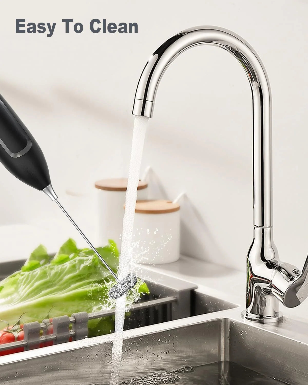 Kitchen faucet with water flowing into a sink, featuring text 'Easy To Clean'.