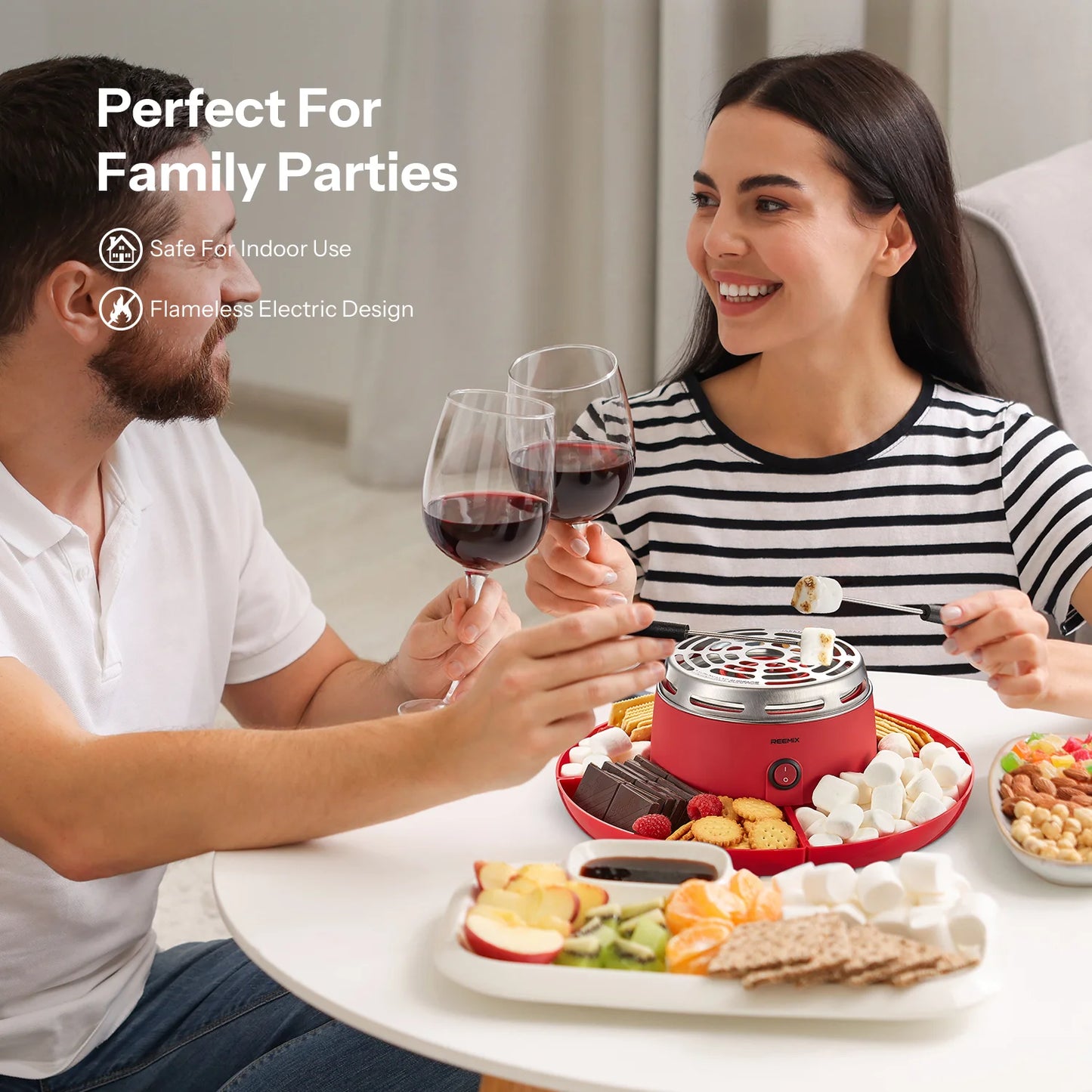 Two people enjoying a meal with a red electric fondue pot, perfect for family parties.